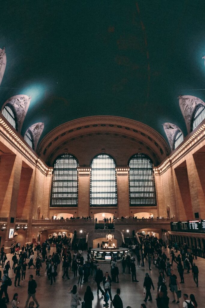 A vibrant scene inside Grand Central Terminal, showcasing architecture and a bustling crowd in New York City.
